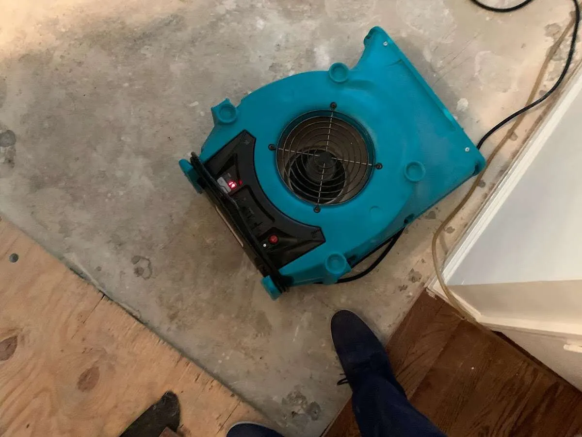 Air mover drying subfloor during Leak Detection & Repair in Merced